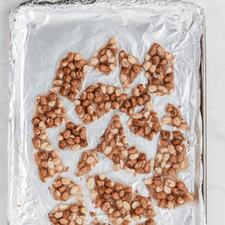 Pecan pralines cooling and setting on foil.