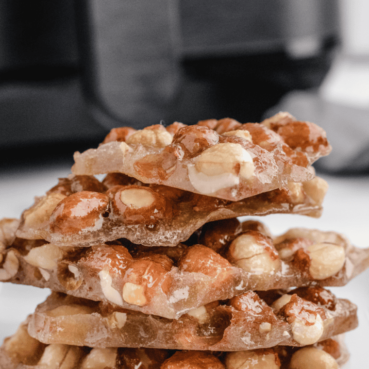 Stack of copycat Buc-ee's pecan pralines on parchment paper