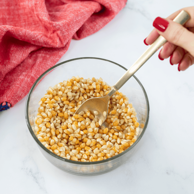 Large rimmed baking sheet lined with parchment paper ready for freshly popped kettle corn