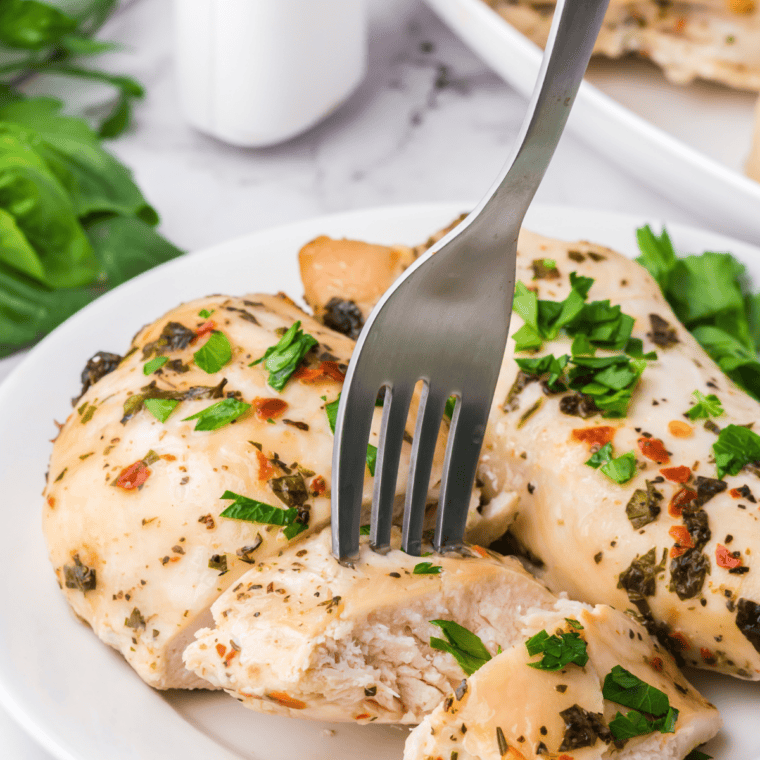 Juicy Tuscan grilled chicken breasts with char marks brushed with garlic herb butter baste