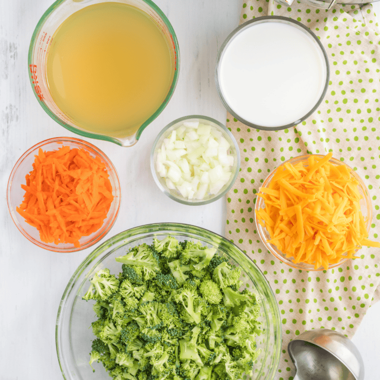 Ingredients for Denny's broccoli cheese soup including broccoli, cheddar cheese, butter, flour, milk, onion, and carrot