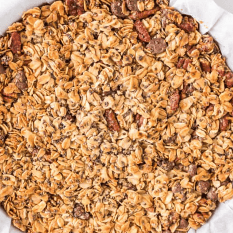 Baked honey almond flax granola cooling on a sheet before breaking into clusters