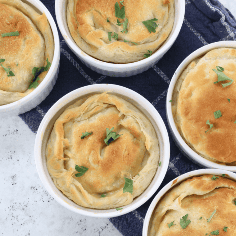 Baked copycat Perkins chicken pot pies with puffed golden crusts on a baking sheet