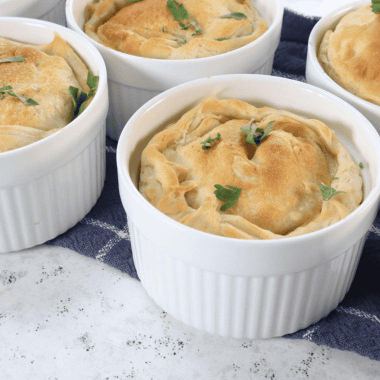 Close-up of copycat Perkins chicken pot pie with steam rising from the creamy filling under a flaky crust
