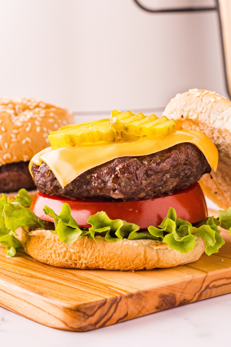 Double smash burger patties stacked with melted cheese on the griddle