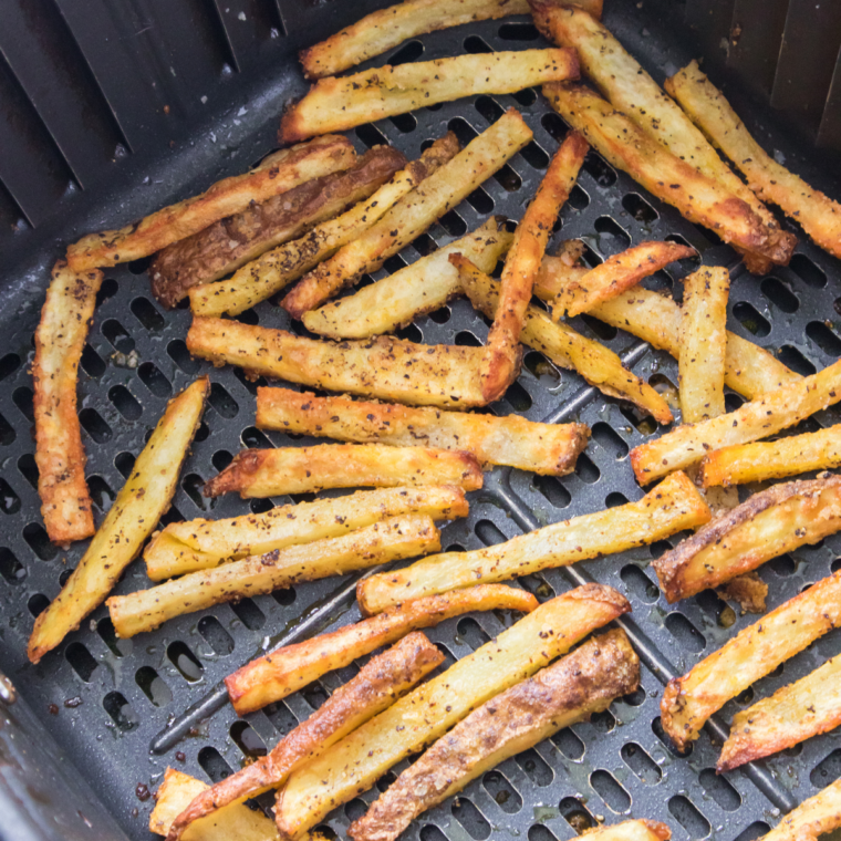Steak and Shake Cajun fries tossed with homemade Cajun seasoning in a bowl