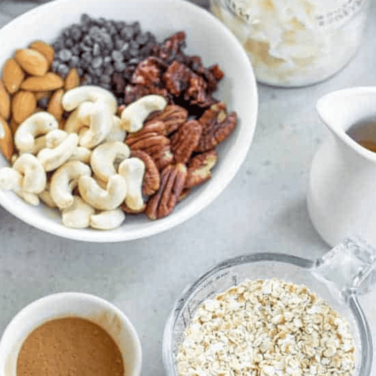 Ingredients for Cracker Barrel granola including rolled oats, sliced almonds, honey, brown sugar, butter, and dried fruit