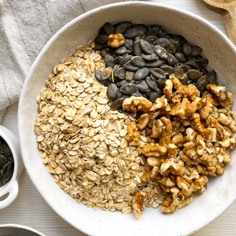 Oats and almonds stirred with honey mixture until glossy for copycat Cracker Barrel granola