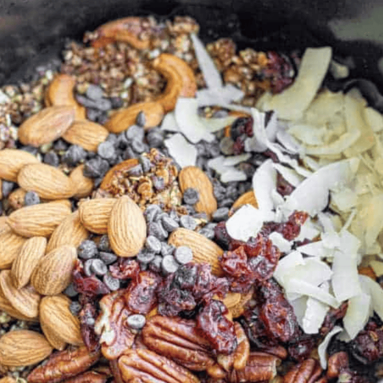 Golden brown honey oat granola fresh from the oven on a rimmed baking sheet