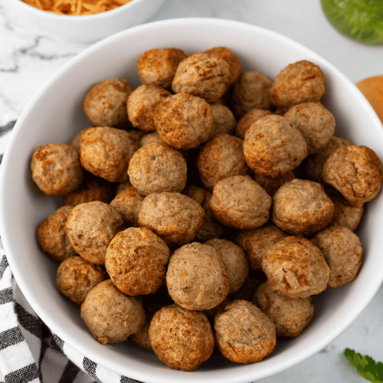 Frozen meatballs, jellied cranberry sauce, chili sauce, brown sugar, and lemon juice on a counter