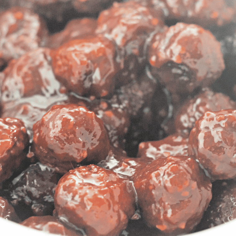 Baking dish of meatballs coated in cranberry chili sauce