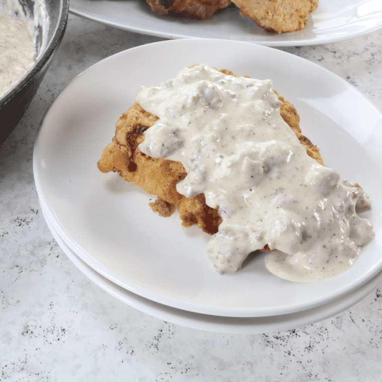 Whisking a splash of milk into country gravy to loosen it before serving