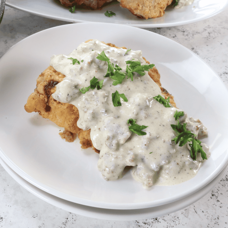 Overhead view of a copycat Denny's country fried steak and eggs breakfast plate