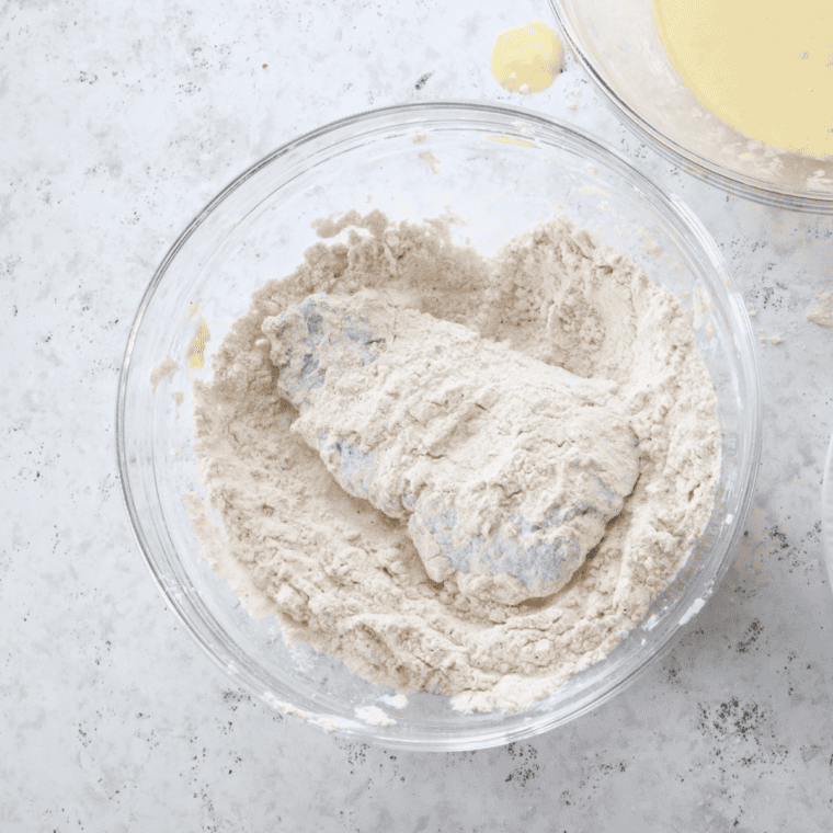 Cube steak pressed into seasoned flour after a buttermilk dip for a thick, craggy coating