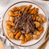 Make Denny's Slow Cooked Pot Roast Bowl at home. Fork-tender chuck roast over red-skinned mashed potatoes with roasted vegetables and rich brown gravy.
