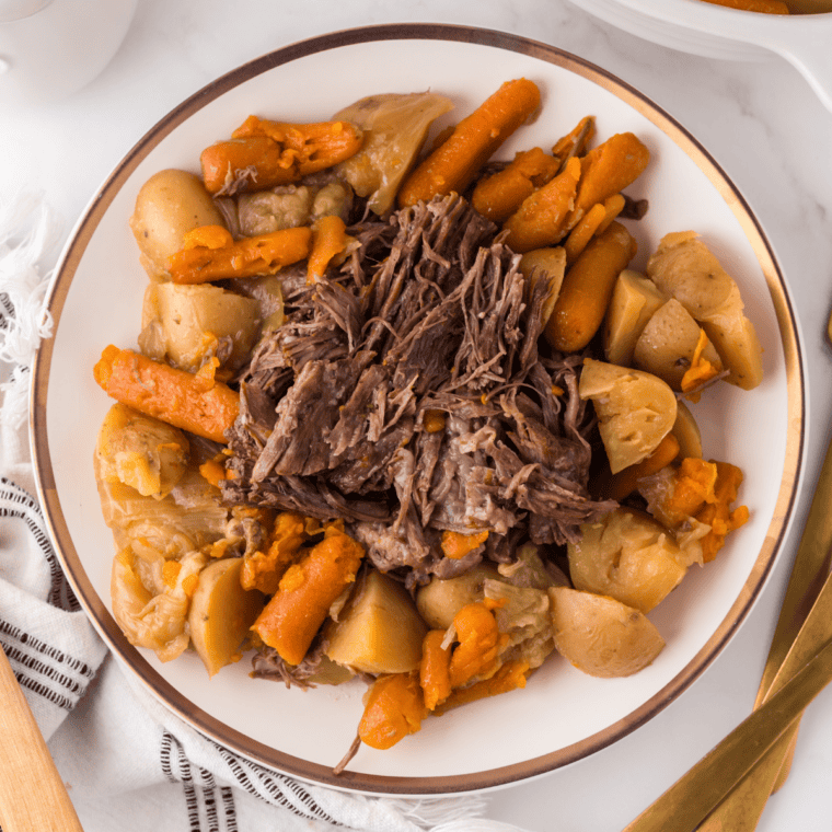 Slow cooked pot roast bowl with fork-tender beef, red-skinned mashed potatoes, roasted carrots and celery in gravy