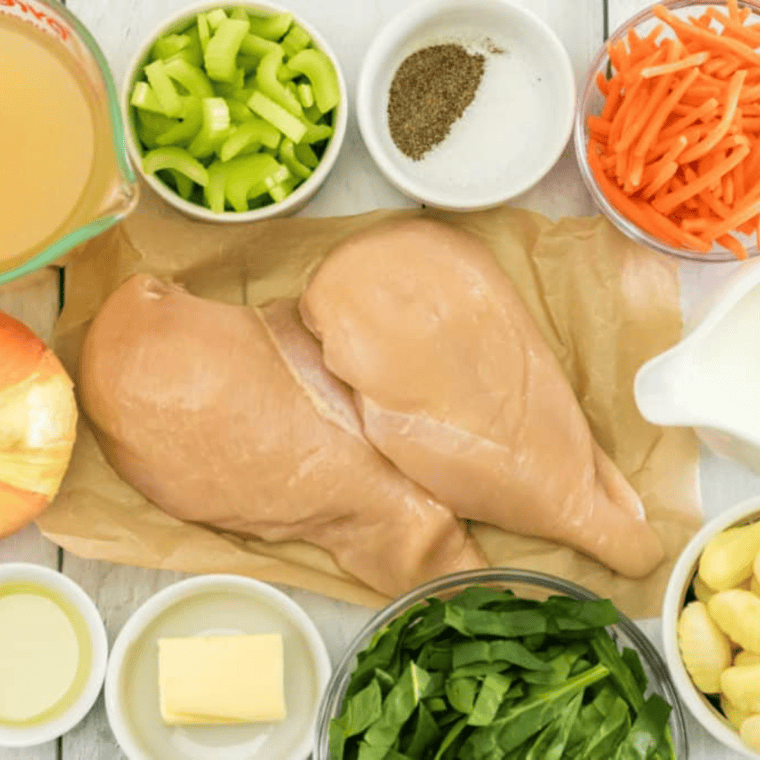 Ingredients for Denny's chicken noodle soup recipe including chicken breasts, egg noodles, carrots, celery, onion, and broth