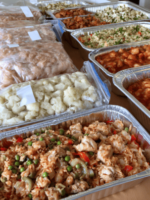 Freezer meals for dinner labeled in freezer bags and foil pans