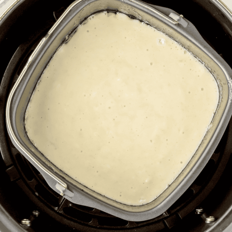 Shaggy buttermilk biscuit dough in a mixing bowl, just combined with a fork
