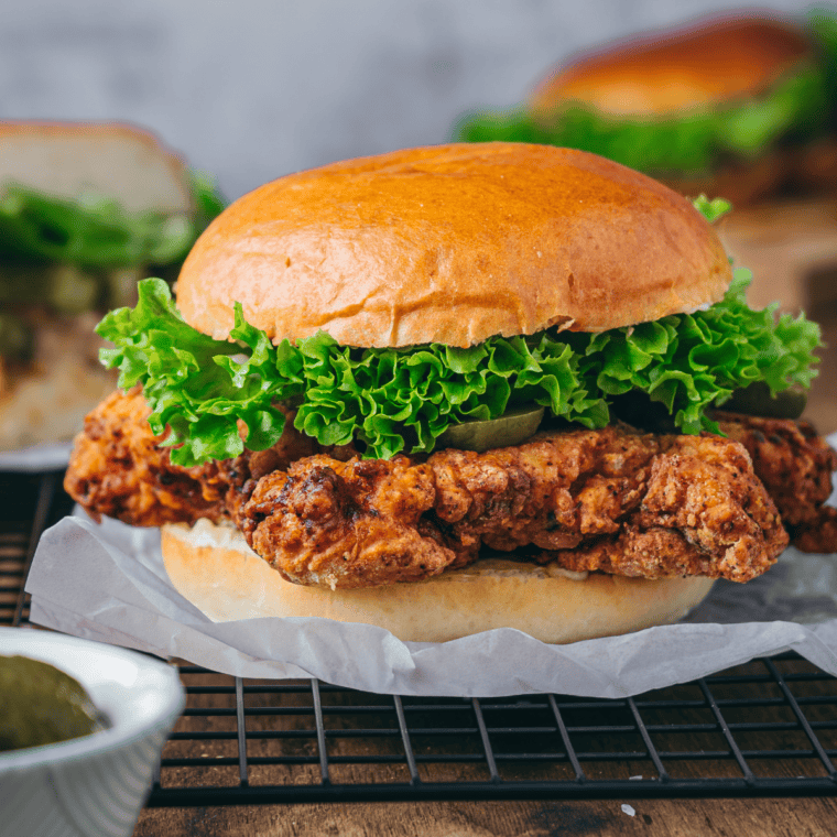 Buttermilk fried chicken served with coleslaw and mashed potatoes on a dinner plate
