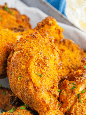 Ina Garten buttermilk fried chicken piled on a white platter with golden crispy coating