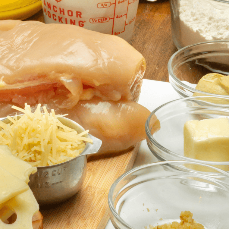 Ingredients for Ina Garten chicken cordon bleu including chicken breasts, ham, Gruyère, Dijon, panko, eggs, and butter