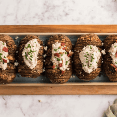 Joanna Gaines-inspired blue cheese dressing in a glass jar with chunky blue cheese crumbles and fresh chives