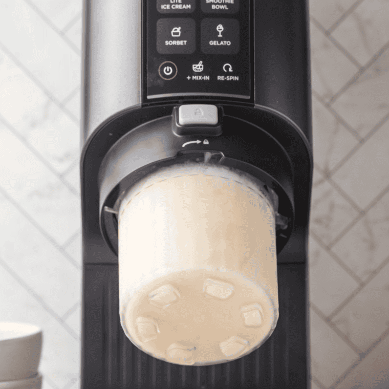 Frozen Reese's Peanut Butter Cup ice cream pint locked into the Ninja Creami with the Ice Cream function selected