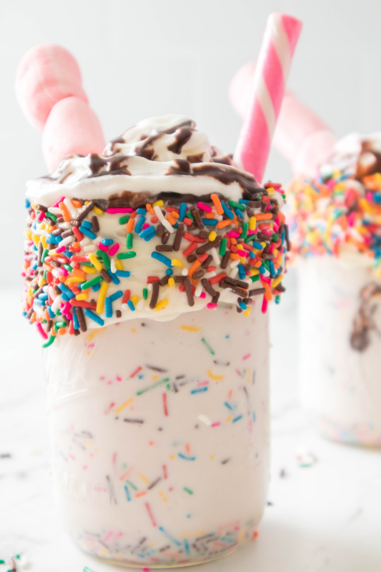 Birthday cake milkshake blended in a blender with vanilla ice cream and cake