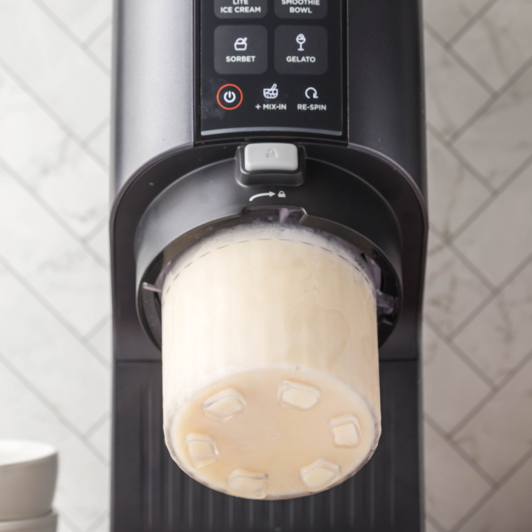 Frozen vanilla ice cream base in a Ninja Creami pint