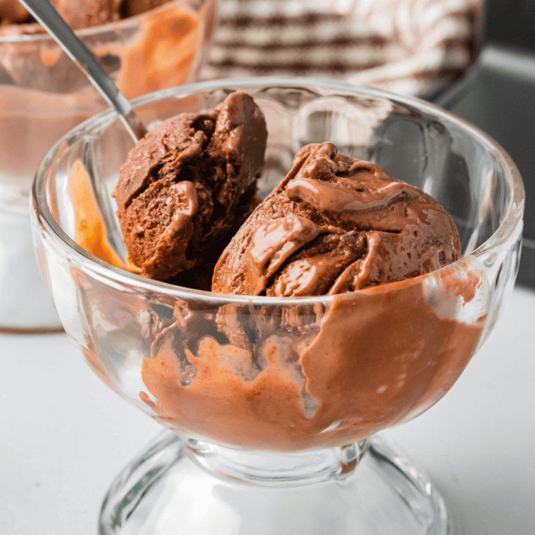 Bowl of Ninja Creami World Class Chocolate ice cream with milk chocolate scoops and a white chocolate mousse swirl