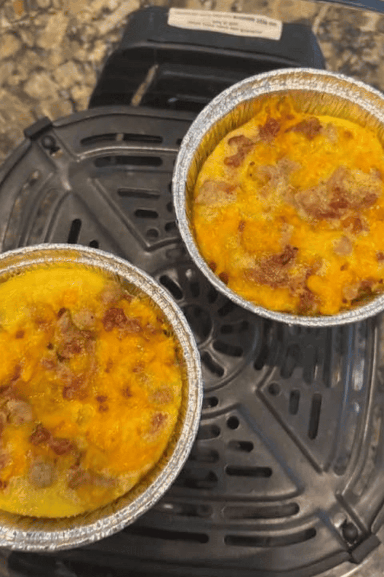 Ninja Crispi breakfast casserole with eggs, sausage and cheese in the 4-quart glass container
