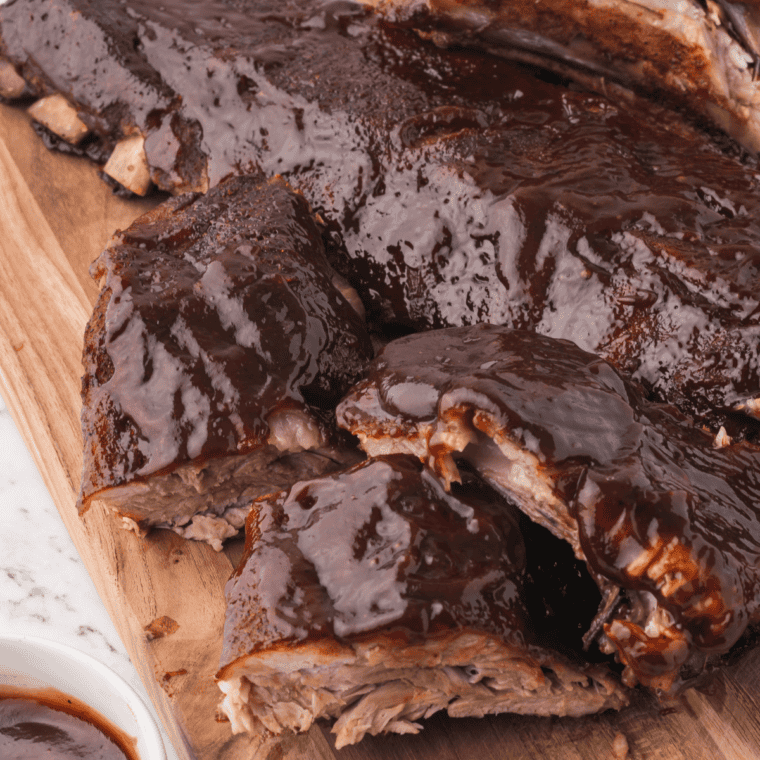 Close-up of copycat Outback baby back ribs with sticky caramelized BBQ glaze and smoky dry rub