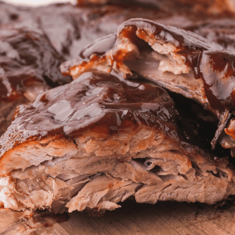 Close-up of tender oven-baked Outback copycat ribs showing meat pulling away from the bone