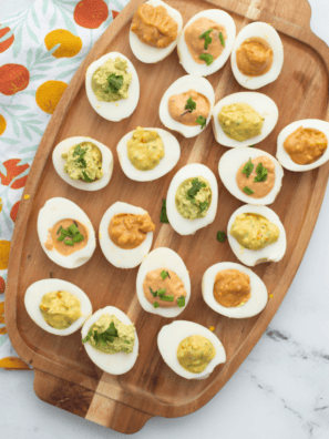 Paula Deen deviled eggs with sweet pickle relish, paprika, and pimentos on a white platter