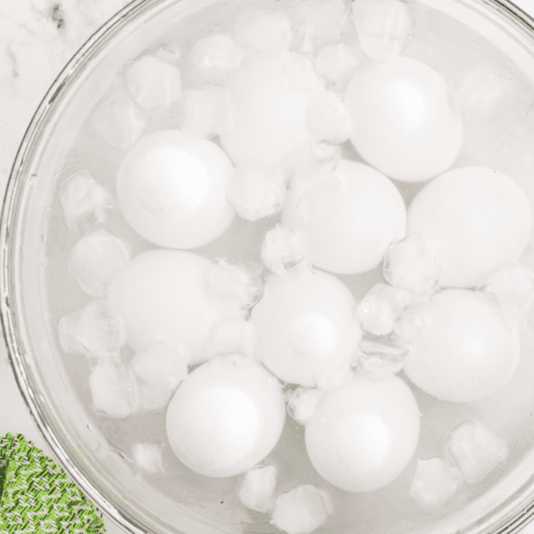 Hard-boiled eggs chilling in a bowl of ice water