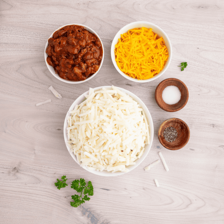 Thawed shredded hash browns pressed dry in a kitchen towel