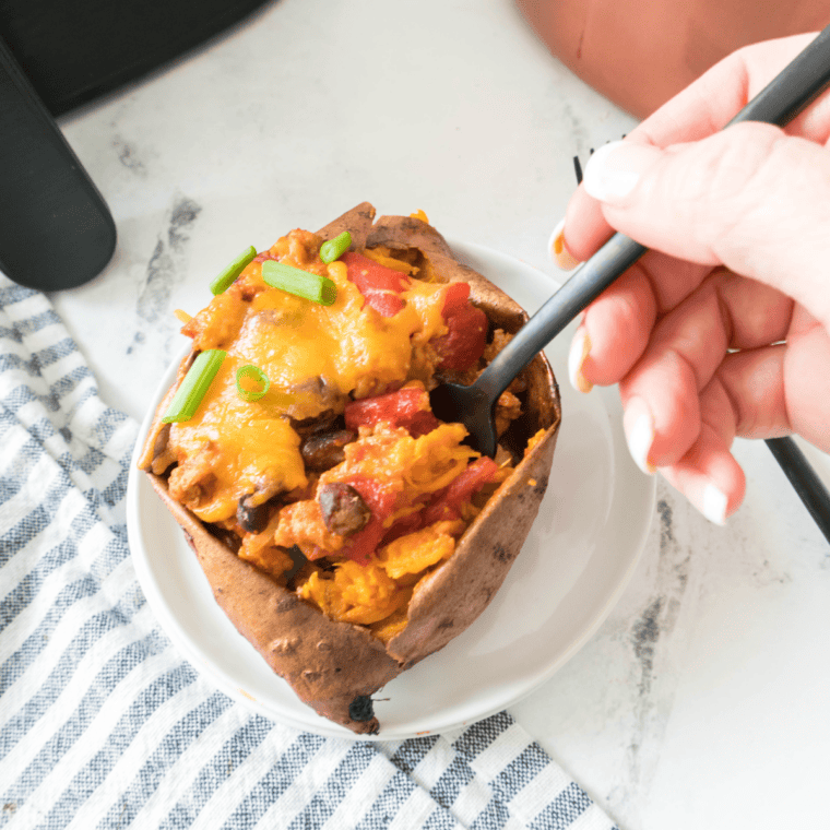 Roasted sweet potato wedges served alongside a bowl of beef chili