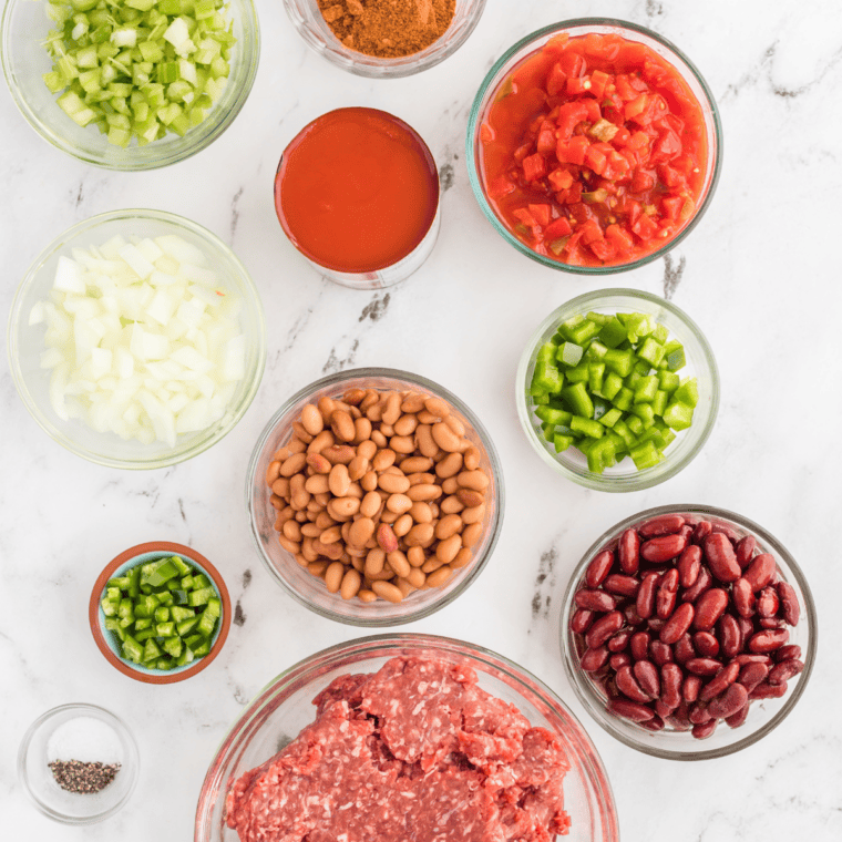 Ingredients for Pioneer Woman chili recipe including ground beef, onion, garlic, canned tomatoes, pinto beans, kidney beans, chili powder, and masa harina