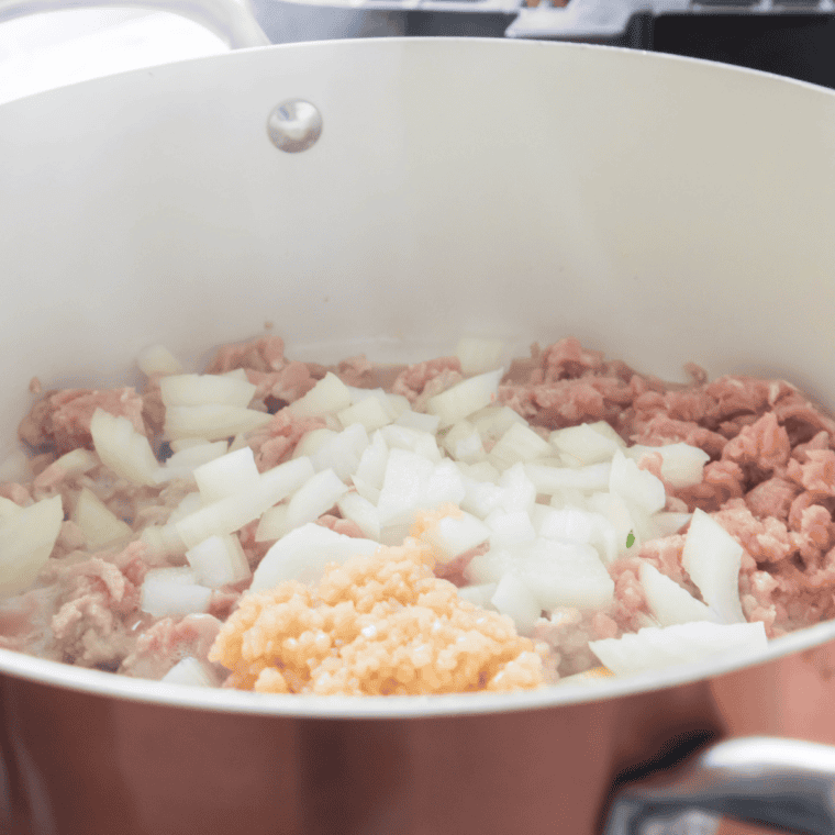 Ground beef browning in a Dutch oven for Pioneer Woman chili