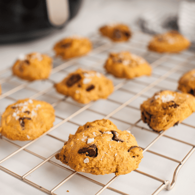 Baked pumpkin snickerdoodle cookies cooling on a wire rack