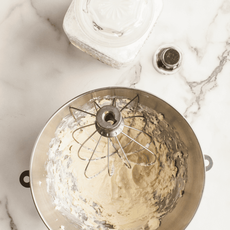 Softened butter and sugar being creamed together in a mixing bowl for pumpkin snickerdoodle cookies