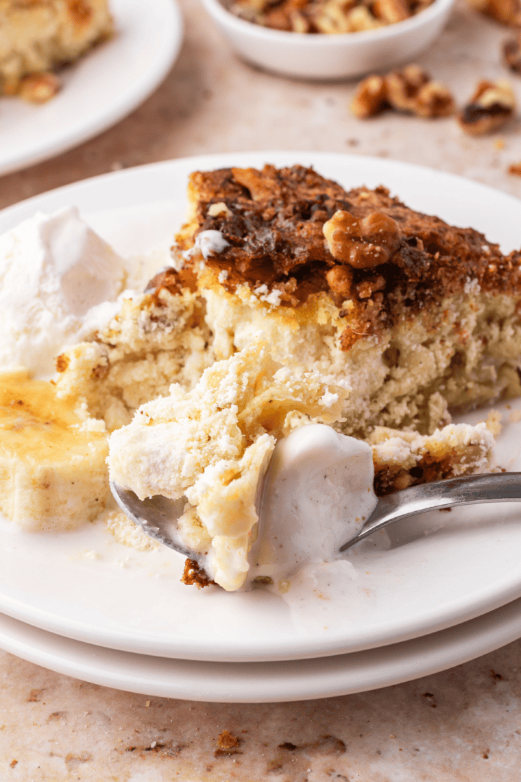 Air fryer banana bread dump cake topped with melted chocolate chips and chopped walnuts
