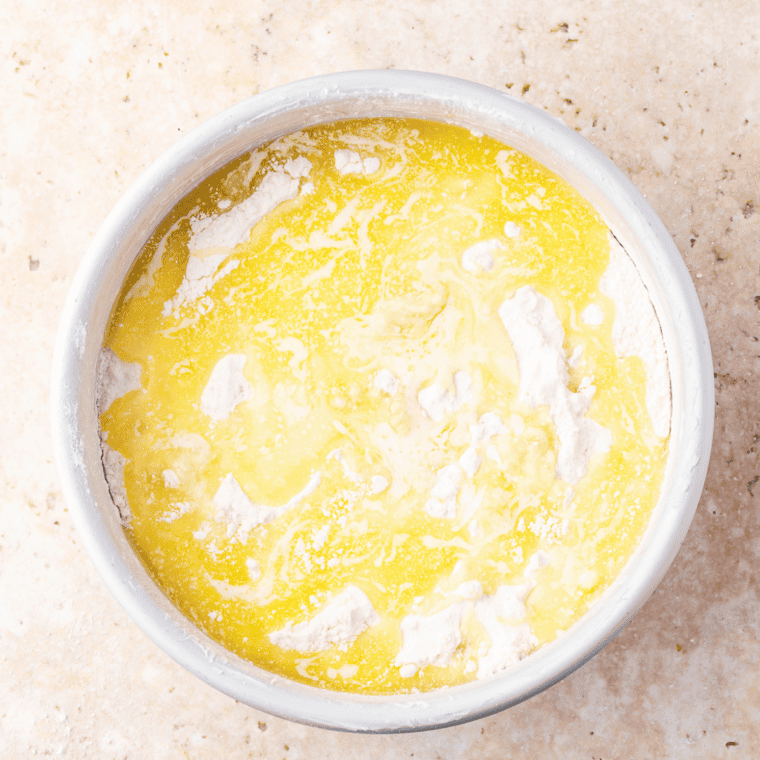 Melted butter drizzled over dry cake mix for air fryer banana bread dump cake