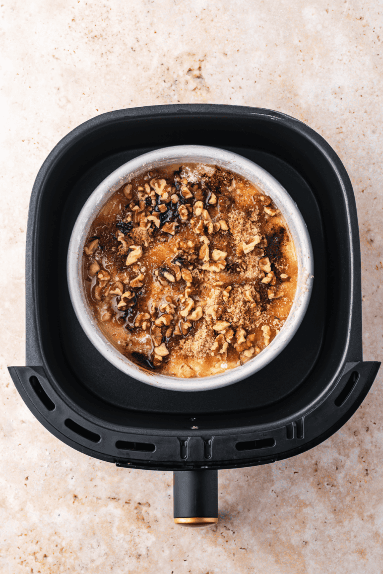 Banana bread dump cake pan set inside an air fryer basket before cooking