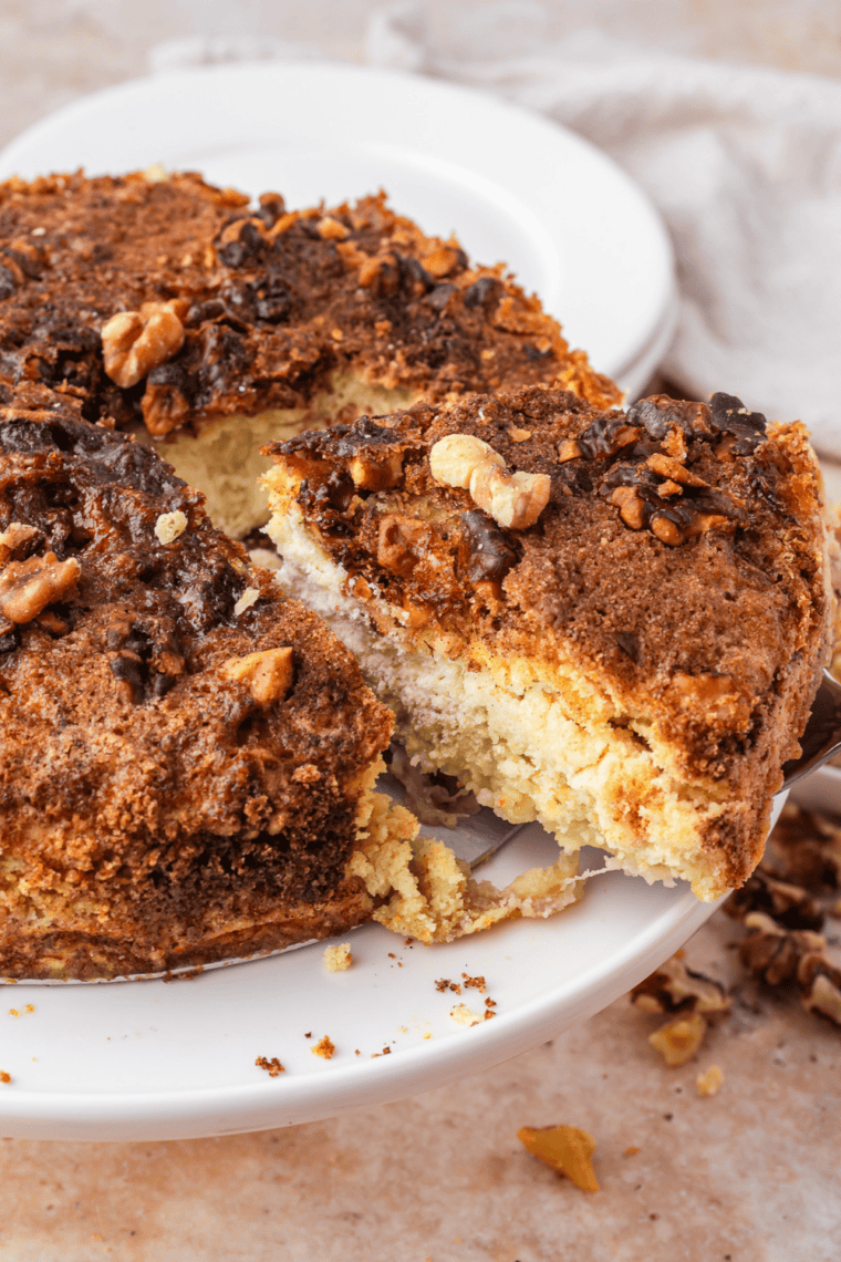 Warm slice of air fryer banana bread dump cake on a plate topped with vanilla ice cream