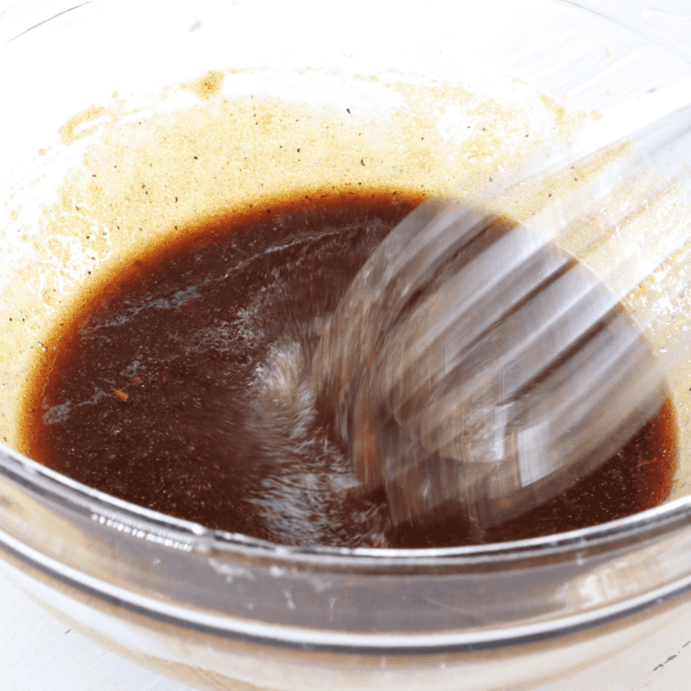 Whisking soy sauce, brown sugar, and garlic marinade for Bohemian Garlic jerky