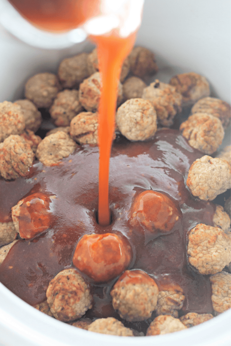 Jellied cranberry sauce and chili sauce stirred together in a slow cooker