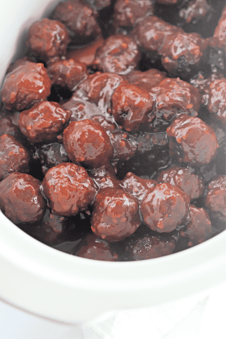 Frozen meatballs added to cranberry chili sauce in a crockpot