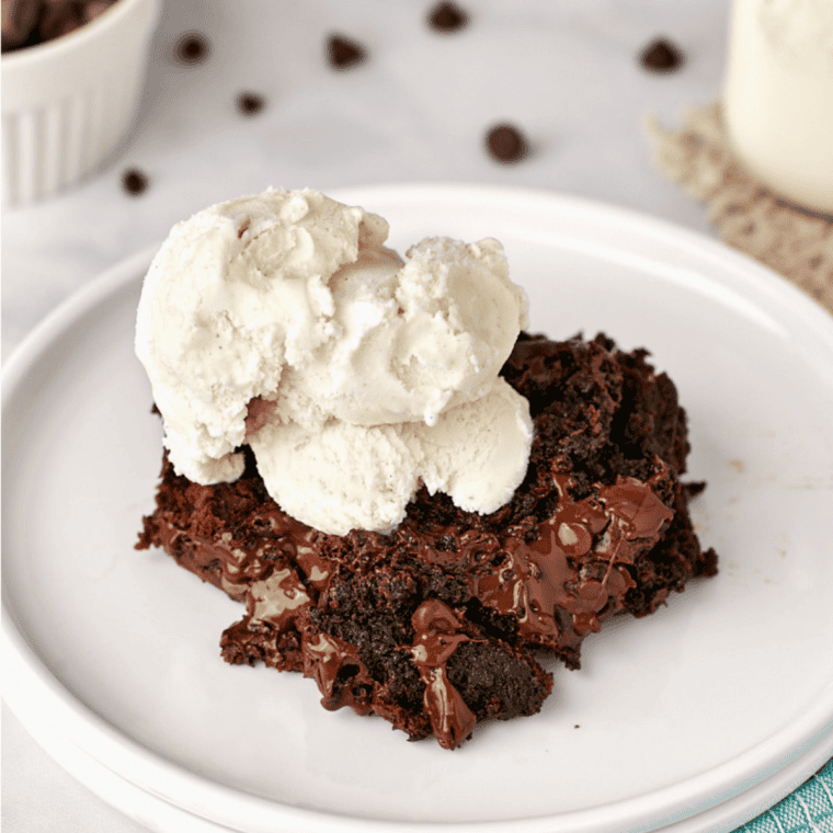 Stack of fudgy Coca-Cola cake squares on parchment paper